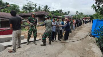 Semangat Membara Warga Bersama TNI Tarik Tali Sling Jembatan Gantung Perintis