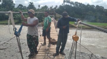 Babinsa dan Tim Percepat Pemasangan Hanger Pengait dan Pasang Papan Jembatan Gantung Kejar Target Cepat Selesai